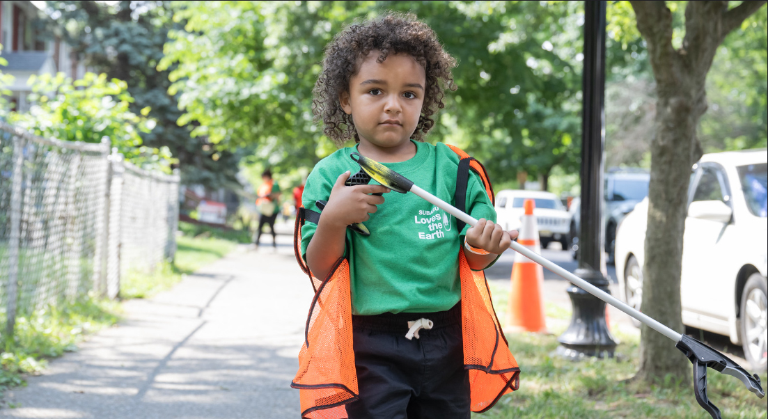 A young child wearing a green 