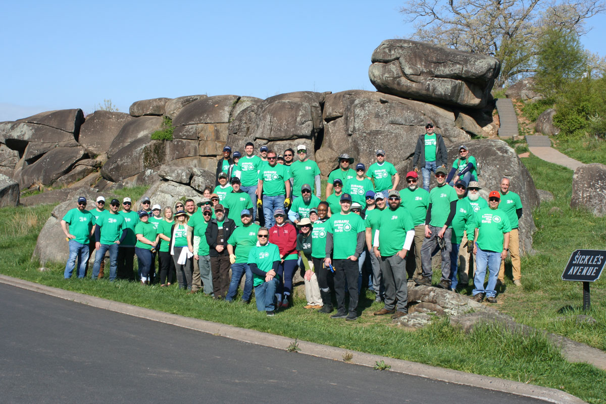 A large group of people wearing matching green 