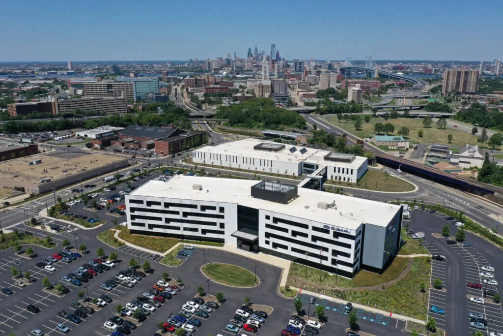 Aerial view of Subaru's Camden, NJ headquarters with the Philadelphia skyline in the distance