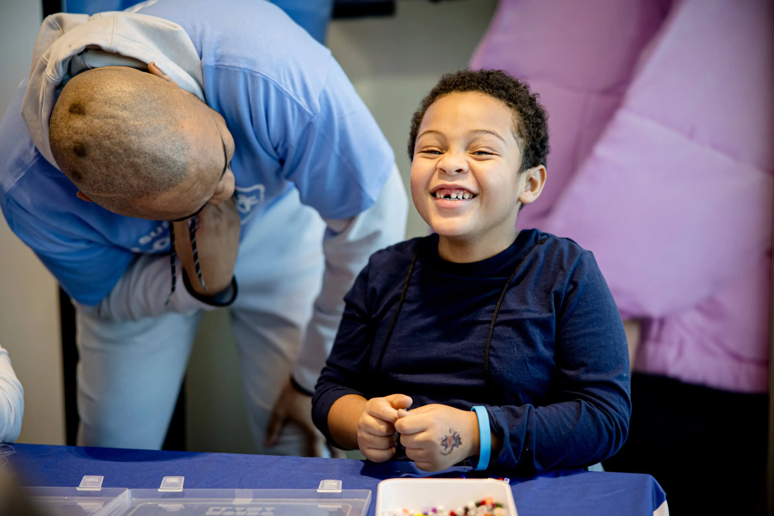 Child smiling during a Subaru Loves to Care event.