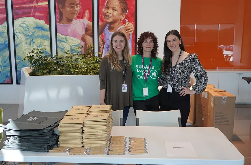 A display of nature and wildlife books spread on a table at the Earth Day Celebration, including "Bringing Nature Home" by Douglas W. Tallamy and Ranger Rick children's books