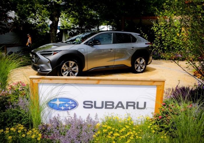 Flower Show subaru sign with car around driveway with flowers